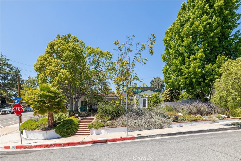 Designed by famed architect Welton Becket (Capitol Records Building, Beverly Hilton Hotel) , sits on one half of a 12000 corner lot. Enter through the front door and into the bright living room with an ornamental fireplace under a gorgeous skylight. The living room looks out onto a covered courtyard patio with a cozy sitting area and large table for year round barbecues and family dinners. The outdoor patio is an entertainer's dream and a wonderful place to hang out on warm Southern California nights. Perfect indoor-outdoor living!
To the left as you walk in the front door is the hallway that leads to good sized bedrooms and a beautiful art deco bath. The rear of the hallway is the master bedroom and master bath. As you look out the windows from the bedrooms it feels like the country with trees and foliage. New air-conditioning mini splits (with remotes) have been added in each bedroom and the living area to add to your comfort. You don’t have to take care of that- the owner pays for gardening service!
When you enter the front door and go to the left and through the dining room you enter the newly remodeled kitchen with a skylight and banquette for breakfast and morning coffee or quick suppers. On the other side of the kitchen is the laundry room and the fourth bedroom with ensuite bath and the guest bathroom.
The fourth bedroom has an entrance off 17th street and can be used as an office or Mother-in-Law Suite.
Bring your green thumb - the front yards are planted with beautiful native california plants. The side yard has two large raised-beds ready for planting flowers or vegetables, and other raised beds have verdant orange, lemon, lime and kumquat trees!
All of this and walking distance to the great shops and restaurants lining Ocean Park Blvd, including Jyan Isaac Bread, the new pizza hang Ghisallo plus the wonderful coffee at Love Coffee and Cafe Bolivar. Who could want a better location!