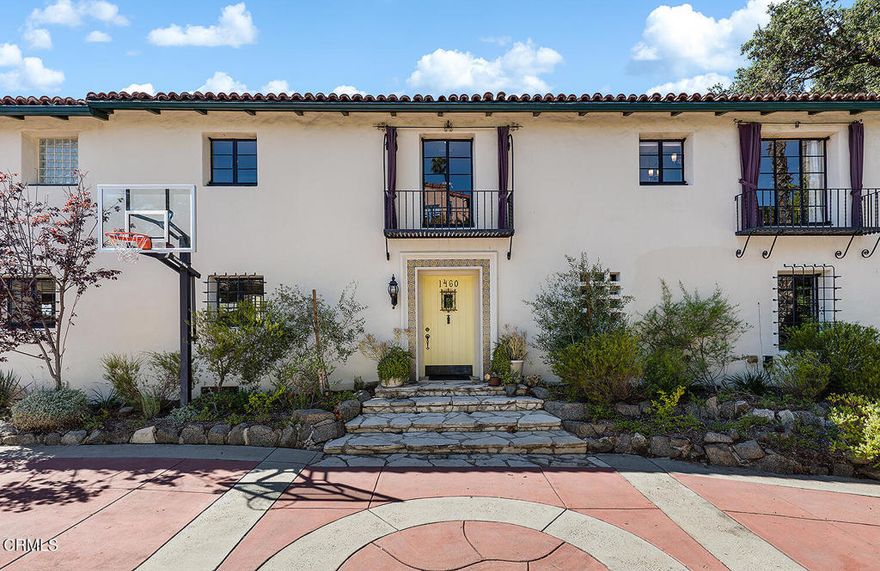 In 1926, at the height of Glendale's golden era of architectural expansion, Samuel G. McClure -- publisher and owner of the Glendale News Press -- purchased a prominent knoll overlooking the growing city below. With an eye for beauty and a taste for the grand, he commissioned the construction of a Spanish masterpiece that would blend the romanticism of old-world design with the grace of California living. Nearly a century later, this extraordinary residence remains one of Rossmoyne's most admired homes - a work of residential art that has stood the test of time. Much like the celebrated Kennedy House in Palo Alto, this residence is a stunning example of symmetrical Colonial Spanish architecture. The home's exterior is defined by its classic proportions and rich period details - handmade decorative tiles, original steel casement windows fitted with wrought-iron grilles, smooth stucco walls, and a series of graceful arches that repeat as a unifying motif both inside and out. Each element tells a story of craftsmanship and splashes of modern artistry enhancements. The stately entry introduces the home's grand scale and impeccable design sensibility. Beyond the foyer, a museum-like formal living room unfolds beneath a soaring wood-beamed ceiling. Light streams through the expansive picture window, illuminating wide-plank wood floors, a commanding fireplace, and a custom wet bar that invites evening conversation. Every corner reveals the thoughtful touch of artisans who had entertaining in mind. The remodeled kitchen reimagines tradition with modern luxury. Anchored by a 60-inch Thermador range, marble countertops, and elegant hardwood floors, it's a playground for the culinary enthusiast - equally suited to quiet breakfasts or grand dinner parties. The kitchen opens seamlessly to a spacious family room, creating a warm gathering space that overlooks the lush grounds and city views beyond. Upstairs, the expansive primary suite serves as a private retreat, framed by stunning vistas of downtown Los Angeles. The en suite bathroom & luxurious custom closet reflect a serene balance between historical charm & updated comfort. 3 additional bedroom suites with beautifully appointed baths complete the home's ideal floor plan, offering both privacy & flow for modern living. Outside, the architecture continues to inspire. A romantic loggia provides a shaded sanctuary for alfresco dining, while the sparkling pool & generous grassy yard invite relaxation & spectacular view