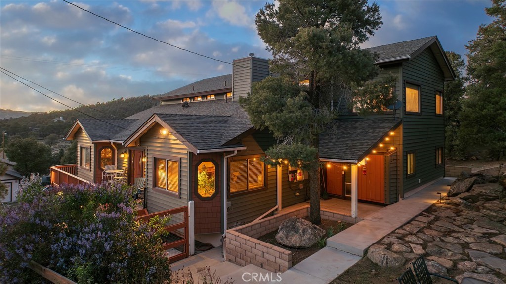 Welcome to your dream equestrian retreat with breathtaking views of Baldwin Lake, surrounding mountains, and glowing sunsets. Situated on over 2 acres of serene land, this rare property blends the tranquility of mountain living with the convenience of nearby access to the High Desert. Boasting over 3,100 square feet of living space, this spacious home features dual suites on both levels, ideal for multi-generational living or hosting guests. A large fenced yard, horse corral, barn, and arena make it a perfect haven for equestrian enthusiasts. Enjoy low-maintenance living with vinyl siding, a 40-year roof installed in 2012, and durable Trex decking for year-round outdoor relaxation. The oversized 2-car attached garage offers ample storage space, while a Generac 14kW whole-house backup generator powered by natural gas ensures you’re never left in the dark. The home is equipped with owned solar panels and sits on a private well, providing energy efficiency and independence. Step outside and soak in the surrounding natural beauty while enjoying unmatched privacy and space. Whether you’re looking to ride, relax, or simply breathe in the mountain air, this one-of-a-kind property offers it all. Equestrian living, stunning views, and sustainable features — all within reach of the valley below. Don’t miss your chance to own a piece of Big Bear’s best-kept secret.