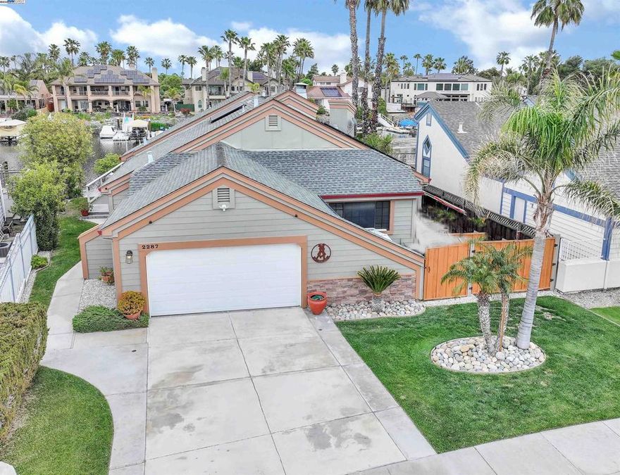 OPEN HOUSE SATURDAY 12/13 1:00 - 3:00 - LIVE WHERE YOU PLAY!! - WATERFRONT LIVING AT IT'S BEST! SINGLE STORY WITH UPDATES THROUGHOUT - PRIME EASTERN EXPOSURE - 3 BEDROOM /2 BATHS - 1814 SQ FT - LEASED SOLAR - ENTERTAINERS BACK DECK W/12X16 HARDTOP GALVANIZED STEEL GAZEBO W/CURTAINS & NETTING - SIDE YARD ACCESS FOR RV/BOAT/JET SKI TRAILER - NEW COMPOSITE REAR DECK & RAILINGS - Open concept living - Tile floor throughout entry, kitchen & walkway -Spacious great room w/high vaulted ceiling, dining area &  gas fireplace - Chef's kitchen w/granite counters, SS appliances & eat at bar - Primary w/newly remodeled bath & cozy woodburning fireplace - Updated secondary bath - New hardware & Lighting fixtures throughout - Newer exterior paint/3yrs - U-Dock w/8000lb hoist w/new motor & canvas cover, jet ski hoist, paddleboard rack, 2 dock boxes - New front entry stamped concrete porch - New front fencing & gates - New garage door & opener w/phone app - New water softener & water heater - New blinds - - New ceiling fans in bedrooms & kitchen - Not in Flood Zone so no Flood Insurance required - All this and more...