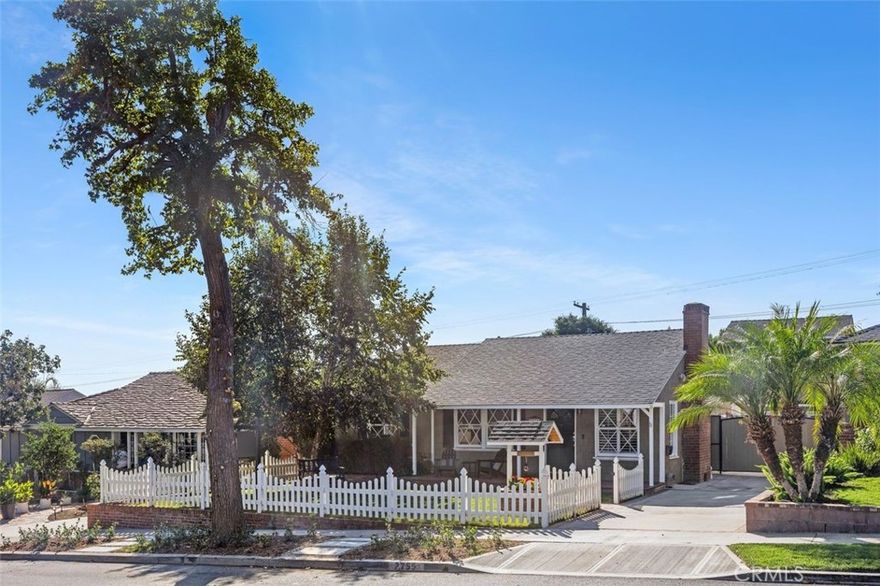 Welcome to this beautifully updated three-bedroom, two-bath ranch home featuring a detached ADU, sparkling pool, and spacious garage. Framed by a white picket fence and mature shade trees, the inviting front yard and patio set the tone for a home full of warmth and character. Step inside to a cozy living room anchored by a wood-burning fireplace, perfect for relaxing evenings. Thoughtfully renovated, the home features an open floor plan that flows seamlessly for everyday living and entertaining. At the heart of the home, the modern kitchen showcases a generous island with breakfast bar seating, new stainless-steel appliances, and abundant storage—ideal for cooking and gatherings. The adjacent dining area offers views of the backyard and opens to a covered patio, perfect for alfresco dining, watching the game, or lounging around the firepit. This versatile space can also be enclosed to create an additional family or media room. The front bedroom, currently used as an office, enjoys garden views. The second bedroom is bright and spacious, while the primary suite serves as a true retreat—complete with a steam shower, large closet, fireplace, seating area, high ceilings, built-in cabinetry, and French doors leading to the pool and garden. Outside, the professionally landscaped garden provides beauty and privacy, while a spiral staircase leads to the detached ADU—a complete guest residence with a full kitchen, dining and seating areas, bedroom, bathroom, and large deck with treetop and hillside views. Perfect for guests, extended family, or a rental opportunity. Situated near top schools, premier shopping, and renowned restaurants, this home offers the perfect blend of comfort, convenience, and California charm.