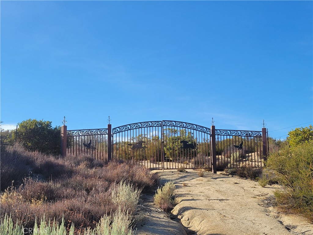 This is a great parcel with gently rolling land, wooded with native trees and vegetation. The property has a permitted well, some cleared areas and a wrought iron gate with fencing along the front of the property. The property is secluded with lots of beautiful nature all around.