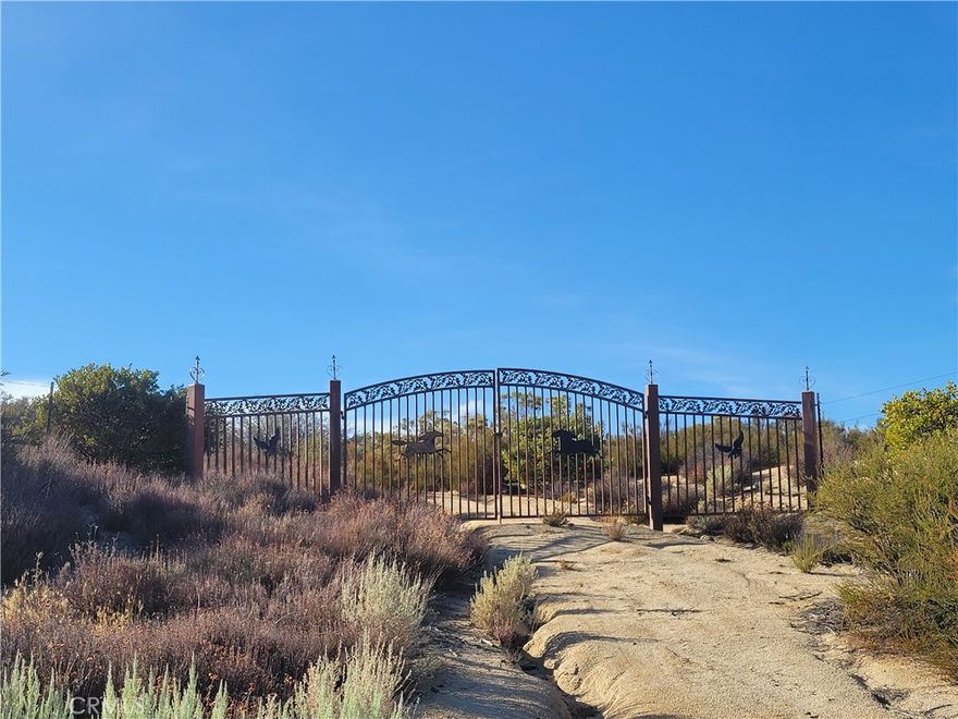 This is a great parcel with gently rolling land, wooded with native trees and vegetation.  The property has a permitted well, some cleared areas and a wrought iron gate with fencing along the front of the property.  The property is secluded with lots of beautiful nature all around.
