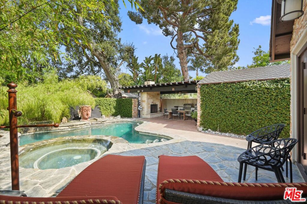 Summer is here, and this beautiful home-sweet-home, centrally located in Valley Village, with private salt-water pool and spa, surrounded with bamboo, is looking for a new owner. Ready for you to move in, and celebrate by the pool and two separate BBQ areas! OR AS AN INVESTMENT PROPERTY! Currently on Airbnb earning over $100K annually. This private oasis, tastefully and beautifully done, awaits you and your guests. The home features 3 bedrooms, 2 full bathrooms, a powder room, family room, living room, dining room, and a Chef's kitchen displaying a beautiful backsplash. The house UPGRADES' feature New Presidential shingle roof, tankless water heater, pool Aqualink System, new Hayward pool heater, water filtration system, whole house water filter, security gate with intercom system, Dave-Lennox HVAC, New A/C unit, R-38 insulation in attic, copper plumbing, solar panels, Brazilian koa flooring throughout the house, exterior video cameras, ADT security system and Nest Thermostat. As you come in through the front yard, featuring Ranchio-Smart sprinkler system, stone veneer, and a mature willow tree, you'll find a well manicured grassy area, perfect for pets. A long driveway with gate, and space for about 4 cars PLUS a detached garage with ADU potential. The living room welcomes you through a sitting-front porch area. As you enter, you're welcomed by beautiful koa flooring throughout and a fire place. The Chef's kitchen, featuring a beautiful cooking setting, with Thermador appliances, includes a six-burner stove with oven, microwave, farmhouse sink, and a generous refrigerator. The kitchen back door gives you access to a BBQ grill, while the family room gives you access to the back private pool area, featuring a spa and covered large BBQ Perquilla-patio, with a fireplace and a fan, where you can place a large table with 8-10 chairs, for entertainment. This area features a propane BBQ, and a charcoal BBQ with additional burner. The main bedroom features large wall mirrors, offers double-door access to spa and pool, a large walk-in closet with built ins, and a very generous beautiful bathroom with heated-marble floors, a floating double sink area with lighting underneath and a large skylight. The shower features three shower heads, marble bench and natural pebble floor. The other two bedrooms are located on the west side of the house, sharing a full size bathroom. This is a great and desirable location, with easy access to the 170 freeway, a couple of blocks away from Oakwood School Secondary Campus, NHSS, Colfax Charter Elementary School, and just a short distance from NoHo Arts District, parks, great restaurants, Universal Studios and more! This is a 1031 Exchange.