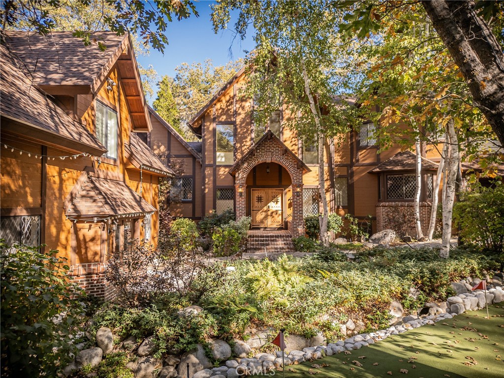 Exquisite Mountain Lodge nestled in the highly coveted Tavern Bay neighborhood, complete with Lake Rights. This remarkable residence presents unparalleled curb appeal, adorned w/ lush landscaping, a serene koi pond, & a beautiful manmade babbling brook & putting green adjacent to the generously sized driveway. Once inside, discover a newly remodeled modern mountain getaway by a highly esteemed LA Designer. This home comes fully furnished giving you a true turn key experience, including new paint & carpeting throughout; a fully renovated kitchen equipped w/ high end appliances including refrigerator, range, & dishwasher. To finish it off, the kitchen is transformed w/ new concrete countertops, updated cabinetry, refined hardware, & a custom one of a kind island. Notable enhancements include a striking new front door, an efficient water heater, a state-of-the-art AC unit in the apartment, advanced thermostats, new toilets & new faucets. The living room boasts a cathedral ceiling complete w/ a fireplace harmoniously adjoining a spacious but cozy family room w/ an additional fireplace. The kitchen flows effortlessly into the dining room to a connecting hallway to the laundry room, an extra storage area, & a relaxing sauna. A perfectly appointed game room includes a table top arcade, darts & games table that converts from pool to ping pong to air hockey to round out the ever sought after memory making experience! The lush primary suite graces the second floor, featuring an expansive ensuite bath and fireplace. A sophisticated loft office & two additional bedrooms are also located upstairs. A second primary suite awaits, equipped with its own fireplace & a charming mini bar. Leading to the exterior, a vast outdoor deck complete w/ a built-in brick BBQ for al fresco dining. A stand-alone playhouse offers a whimsical retreat for children or can be transformed into a tranquil meditation space. For the discerning automobile aficionado, the property includes a heated 3-car garage & an additional heated 4-car garage, ensuring ample space for your family & guests. And as a huge bonus, included in the purchase is a 2022 Sea Doo 18ft Boat w/ only approx 23 hrs. Also equipped w/ a reliable generator, this property offers an ideal layout, has been thoughtfully renovated & restored & is walking distance to Tavern Bay Beach Club. With a generous 4,050 square feet of living space, embrace a life of opulent serenity on Osprey Lane. Showings by appointment.