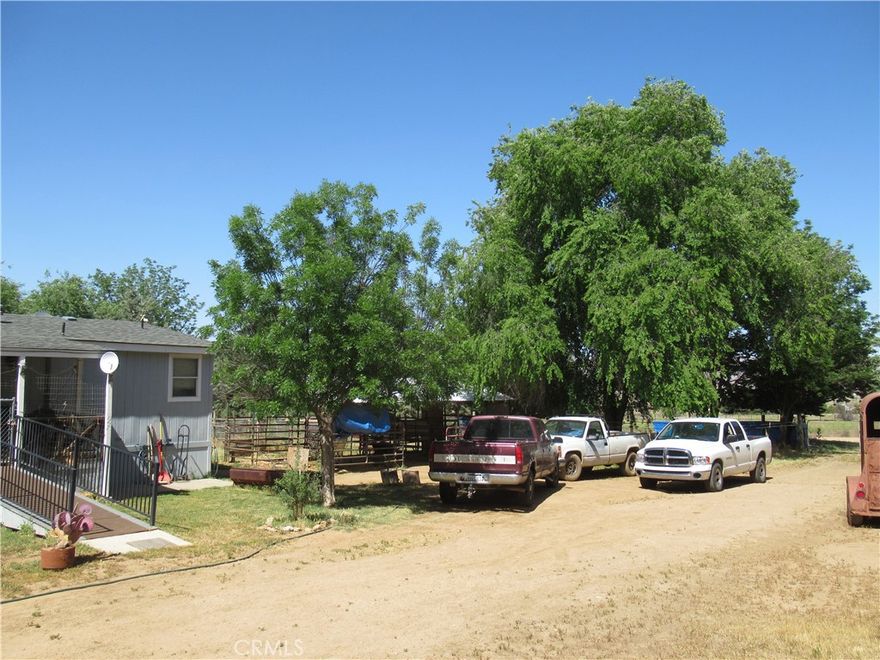 This well maintained 1560 sq. ft. modular home has 3 bedrooms and 2.5 baths. It  sits on 2.5 acres with a variety of  very well established landscaping that give a secluded, private setting. Close to the foothills in a known good water area with fantastic vistas. It includes a small fruit orchard that includes  apples . pears & figs. Lots of room for animals like sheep, goats , horses ,chickens.  Fully fenced and cross fenced. The property also includes a large detached shop.  There is an FHA loan that is assumable to qualified buyers at 3.375%