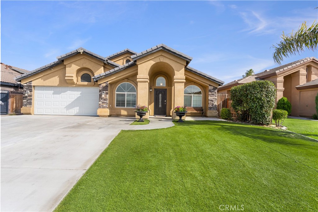 Beautiful 5-Bedroom Home with Stunning Kitchen in Prime Location! Gorgeous & thoughtfully designed split wing floor plan blending style & functionality. Stunning kitchen w/island, recently remodeled w/generous white cabinetry, glass inserts, granite, stainless appliances, recessed & pendant light fixtures. Two spacious living rooms, dining & breakfast areas & an indoor laundry. The guest bath has granite vanity top, the owner's bath offers sep. shower, jetted tub, dual sinks & granite. Three bedrooms have walk-in closets. The common areas have tile & luxury wood look flooring. Another upgrade is the high vaulted ceiling patio, permitted (per the owner) w/lights, pre-wired for fans & extended stamped concrete, plus 2 block fences for additional privacy. The garage door, coach lights & carpet in 4 bedrooms were just replaced. Front yard has artificial grass for low maintenance & water saving. This home has Solar PPA. This is a must see! Don't miss the chance to make it yours.
