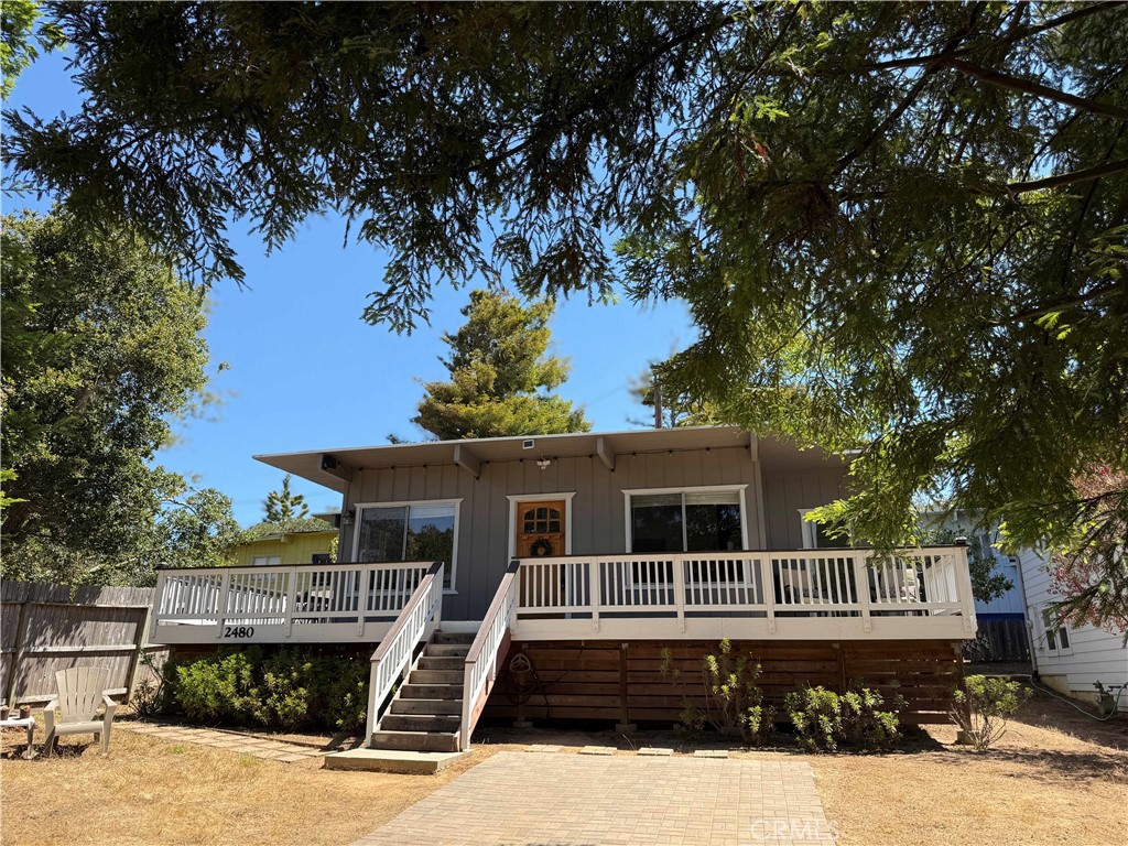 This mid-century cottage is tucked behind mature redwood trees and is located near an entrance to the Fiscalini Open Space Ranch Preserve and walking distance to the ocean. There is a large front yard which also provides off-street parking. Up a few stairs toward the front door, a wrap-around deck offers places to enjoy the sunshine, the birds or views of the local deer and turkeys! Once inside the home, you will find a large single level, open floor plan with painted wood ceilings, large picture windows and a free-standing wood fireplace. The central kitchen has solid surface quartz counters and a tile backsplash. There are two bedrooms, each with access to the wrap-around deck. Each bedroom has an en-suite bathroom. A laundry/mud room adds extra cabinetry and perhaps a place for crafts studio or office. This is a very charming Cambria cottage in a fantastic location!