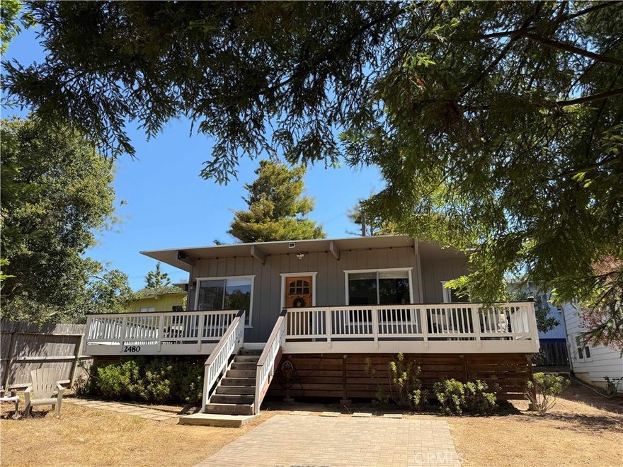 This mid-century cottage is tucked behind mature redwood trees and is located near an entrance to the Fiscalini Open Space Ranch Preserve and walking distance to the ocean. There is a large front yard which also provides off-street parking. Up a few stairs toward the front door, a wrap-around deck offers places to enjoy the sunshine, the birds or views of the local deer and turkeys!  Once inside the home, you will find a large single level, open floor plan with painted wood ceilings, large picture windows and a free-standing wood fireplace. The central kitchen has solid surface quartz counters and a tile backsplash. There are two bedrooms, each with access to the wrap-around deck. Each bedroom has an en-suite bathroom. A laundry/mud room adds extra cabinetry and perhaps a place for crafts studio or office. This is a very charming Cambria cottage in a fantastic location!