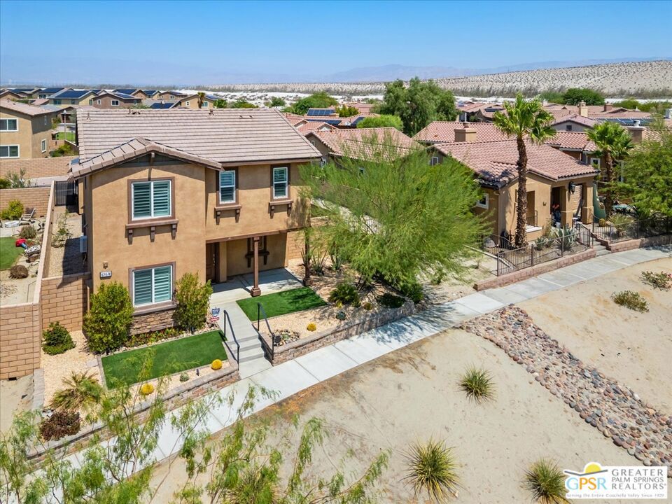 Perfect for commuters, frequent entertainers, or a small but growing household, this comfortable two-story home offers 3 bedrooms and three bathrooms plus a detached two-car garage in an easy location just off the 10 freeway. The home's street entrance has a small covered porch and opens into the first floor which features an island kitchen, living room, and one of the guest bedrooms and baths. The entry from the detached garage & backyard opens into the kitchen and living room area. Upstairs, the primary ensuite bedroom offers privacy from the second guest bedroom and bathroom with additional loft space that was used a an office space but could also be an additional lounging or media area. The laundry is conveniently located on the second floor. Vinyl plank flooring is throughout the first level with carpeted bedrooms, loft and stairs. Smart Home features include security system, keyless entry & video doorbell. The home is equipped with a whole house fan system and two solar panel arrays on a transferrable power purchase agreement with Sun Run. The backyard is large enough for gatherings and daily outdoor living and designed for low maintenance with desert friendly plants and two raised beds for seasonal plantings. There is also electrical supply for a free-standing hot tub. Verano is a well located master planned community located just blocks from grocery shopping and a quick drive to dining and shopping in Palm Springs, Cathedral City, and Rancho Mirage. Community amenities include a clubhouse, fitness room, pool & spa, with pocket parks throughout the community and a 3-acre private gated park across the street from this home that features a playground, field, splashpad, pickleball courts, and shaded tables. The community is also wrapping up construction on a lap pool to compliment the large community pool. Discover Verano and experience all it has to offer!