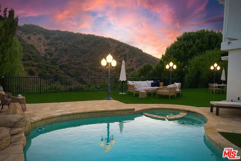 Nestled in the coveted Encino Hills and set against a backdrop of serene canyon views, this beautifully renovated 5-bedroom, 6-bathroom estate offers the perfect blend of luxury, comfort, and convenience. Spanning nearly 4,800 square feet, this spacious home is located within the highly sought-after Lanai Road School District. Step inside to discover an expansive floor plan designed for both entertaining and everyday living. The heart of the home is the gourmet kitchen, complete with high-end appliances, sleek finishes, and ample counter space for the most discerning chef. The living and dining areas flow seamlessly, offering abundant natural light and tranquil views of the surrounding canyon. Each bedroom is generously sized, but the true showstopper is the oversized primary suite your private oasis featuring a spa-like bathroom and a large walk-in closet. Additional highlights include multiple entertaining spaces, elegant finishes throughout, and thoughtful design elements that elevate the entire home. Enjoy easy access to both Ventura Boulevard and Mulholland Drive perfectly positioned just minutes from premier shopping, dining, and top-rated private schools. An expansive lower portion of the lot offers incredible potential space ideal for those looking to elevate their outdoor lifestyle. Whether you're relaxing on the patio with a morning coffee or hosting guests in one of the spacious indoor/outdoor living areas, this exceptional property captures the essence of California living.