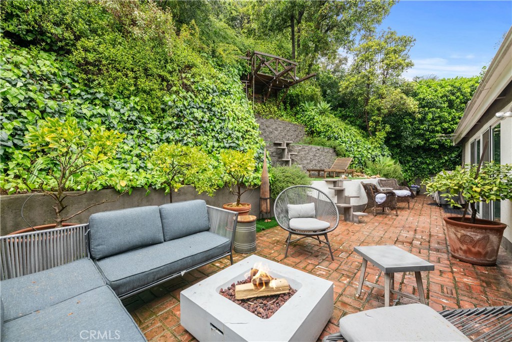 Located in the serene Beverly Glen Canyon just minutes north of Sunset Blvd, this enchanting retreat awaits. Step inside the welcoming main foyer and discover a spacious studio ideal for remote work or a music studio. Journey up the stairs to the cozy family room with a gas fireplace, kitchen with central island and breakfast bar, and double patio doors opening to a private outdoor oasis with a soothing water feature. The bright primary bedroom boasts built-in closets and an ensuite bathroom with a tub. Two additional bedrooms, one currently serving as an office, offer versatility. Conveniently situated near UCLA, Century City, Brentwood, Beverly Hills, and major studios in the Valley and beyond. Nearby community market and park, as well as the Glen Center with dining and entertainment options. An effortless commute with easy access at the top of the street and a direct route to the beach via Sunset Blvd in just 20 minutes.