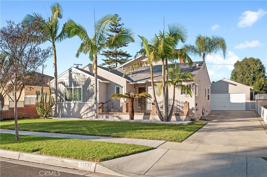 Welcome to this beautifully maintained 4 bedroom, 3 bath home offering 2,300 sq. ft. of bright, comfortable living space. Step inside to find an open-concept layout featuring a spacious living room, a modern kitchen with ample cabinetry and sleek countertops, and a dining area perfect for everyday meals or entertaining guests. The main level includes a generously sized primary suite with a private bath, plus 2 additional bedrooms that offer flexibility for family, guests, or a home office.  The downstairs family room provides even more room to relax, play, or work. The second story leads to a private extra spacious primary suite with jacuzzi tub, walk in closet and french doors that led to the balcony that overlooks the neighborhood.  Elegant hardwood floors throughout most of the home with the exception of the tiled kitchen, bathrooms & the carpeted second story suite. Outside, enjoy a private backyard with plenty of space for gatherings, gardening, or quiet evenings outdoors.  Bonus patio space behind the garage that is currently being as a private outdoor entertainment area with TV, speakers etc...perfect for watching your favorite sports.  The long driveway leads to the detached 2 car garage = plenty of parking....here's your opportunity to finally purchase that RV you've always wanted!  Conveniently located near shopping, dining, schools, and parks — this home combines comfort, space, and convenience in one exceptional package. Don’t miss the opportunity to make it yours!