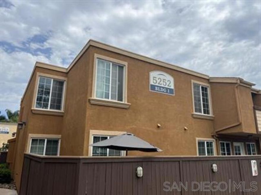 This charming upstairs townhome located in the desirable gated community of Balboa Ridge. This home offers a perfect blend of style, comfort, and convenience.  Enjoy a spacious living room with vaulted ceilings and hardwood flooring throughout, complemented by brand new carpet in both bedrooms. The modern kitchen features granite countertops and stainless steel appliances, perfect for home chefs.  Additional highlights include split A/C units, an in-unit stackable washer and dryer in a dedicated laundry closet, and a private balcony accessible from the living room—ideal for relaxing or entertaining.  This unit includes one assigned parking space and access to community amenities such as a pool. Located within walking distance of shops, restaurants, and more, this home offers the best of Clairemont Mesa living.