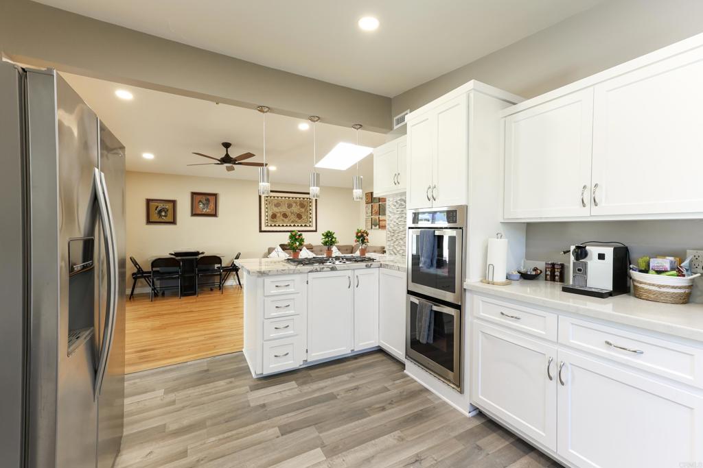 Centrally located and beautifully updated, this 4-bedroom, 2-bath home is move-in ready with all the right improvements. The remodeled kitchen features modern finishes and flows seamlessly into the living areas, while both bathrooms have been tastefully renovated. Hardwood floors run throughout, complemented by recessed smart lighting. Major upgrades include a newer roof (2022), water heater, and A/C for peace of mind. The backyard offers a covered patio and mature fruit trees—perfect for relaxing, entertaining, or enjoying homegrown treats. With paid solar, you’ll love the energy savings. A wonderful blend of comfort, convenience, and style!