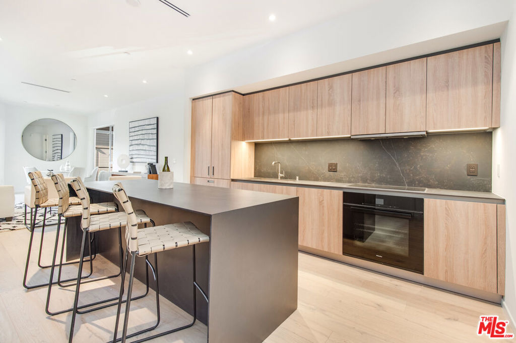 MOVE right into this stylish, modern, luxurious, end unit condominium in a very desirable, sustainably conscious, architectural building designed by award winning LOHA architects! Step into a sunlit open floorplan that has privacy in mind, with primary and guest suite on opposite ends of the living space. Wide planked floors, 10-foot ceilings, floor to ceiling windows, generous, organized, walk in closets in both bedrooms. Dramatic, spa-style primary bathroom with spectacular floor to ceiling bookend slabs in the walk-in, half-glass shower with beautiful Waterworks hardware. Sleek Bauformat kitchen with a movable waterfall island. Miele appliances and laundry. Spacious private balcony with views of the hills above the Sunset Strip. Spacious pantry/flexible closet in living area. Custom window treatments, 2 tandem parking spaces, additional storage cabinet in the garage. State of the art fitness center, yoga/sun deck, outdoor dining and lounge community area with fire pit. Smart, secure entry via Butterfly MX. Convenient to Gelson's, shopping and cafes on Santa Monica Blvd, Melrose Place and all of West Hollywood. Move in, relax and ENJOY the L.A. lifestyle in this gorgeous unit!