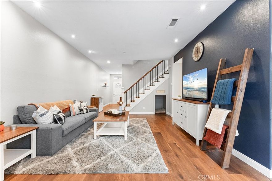 Less than a mile from the sand, this beautifully upgraded Pelican Pointe residence offers peaceful coastal living in a quiet interior location with its own private yard and direct access to the community pool. Thoughtfully designed across two levels, the home features soaring ten foot ceilings, abundant natural light, and a bright open layout that elevates both daily living and entertaining. The main level includes an upgraded kitchen that connects seamlessly to the living areas, a convenient half bath for guests, and direct access from the oversized two car garage. The private backyard patio extends the living space outdoors, creating an ideal setting for relaxing, dining, or hosting friends. Upstairs, the primary suite offers a private balcony, a generous walk in closet, and an upgraded en suite bath. Two additional bedrooms provide excellent size, versatility, and ample closet space, making them ideal for guests, work, or retreat. With thoughtful enhancements throughout, an exceptional location, and the best of Huntington Beach just moments away, this move in ready Pelican Point home stands out as a rare coastal opportunity.