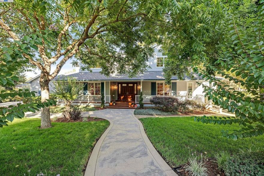 Nestled in an exclusive neighborhood adjacent to The Club at Castlewood and the Pleasanton Ridge, this stunning, meticulously-maintained, custom farmhouse-style home is a rare find, welcoming you with an expansive wraparound porch fronting serene open space. Inside, the home has a classic open layout with high ceilings, newly refinished Brazilian cherry hardwood floors, and new carpeting. Fresh paint, new windows, and French doors create a bright, airy feel. The elegant formal living and dining rooms flank the entryway, highlighted by a graceful, curved staircase. The spacious kitchen is a chef’s dream, equipped with Thermador range, Sub-Zero built-in refrigerator, butler's pantry, 500+ bottle wine storage, and informal dining seamlessly flowing to the open family room. The first floor has a stately office, half bath, and spacious bedroom with ensuite bathroom. Upstairs, two bedrooms share a Jack & Jill bathroom, and the primary suite offers a fireplace, spa-like bathroom, and generous walk-in closet. Manicured yards feature decks, raised garden beds, and your own vineyard. The 4-car garage includes extensive attic storage. Premium cul-de-sac location ensures a peaceful setting near downtown, served by award-winning schools, and easy access to I-580/I-680. No HOA/fees.