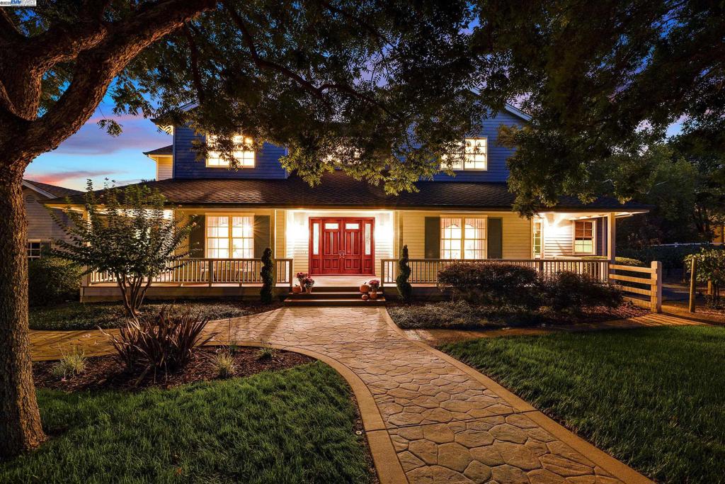Nestled in an exclusive neighborhood adjacent to The Club at Castlewood and the Pleasanton Ridge, this stunning, meticulously-maintained, custom farmhouse-style home is a rare find, welcoming you with an expansive wraparound porch fronting serene open space. Inside, the home has a classic open layout with high ceilings, newly refinished Brazilian cherry hardwood floors, and new carpeting. Fresh paint, new windows, and French doors create a bright, airy feel. The elegant formal living and dining rooms flank the entryway, highlighted by a graceful, curved staircase. The spacious kitchen is a chef’s dream, equipped with Thermador range, Sub-Zero built-in refrigerator, butler's pantry, 500+ bottle wine storage, and informal dining seamlessly flowing to the open family room. The first floor has a stately office, half bath, and spacious bedroom with ensuite bathroom. Upstairs, two bedrooms share a Jack & Jill bathroom, and the primary suite offers a fireplace, spa-like bathroom, and generous walk-in closet. Manicured yards feature decks, raised garden beds, and your own vineyard. The 4-car garage includes extensive attic storage. Premium cul-de-sac location ensures a peaceful setting near downtown, served by award-winning schools, and easy access to I-580/I-680. No HOA/fees.