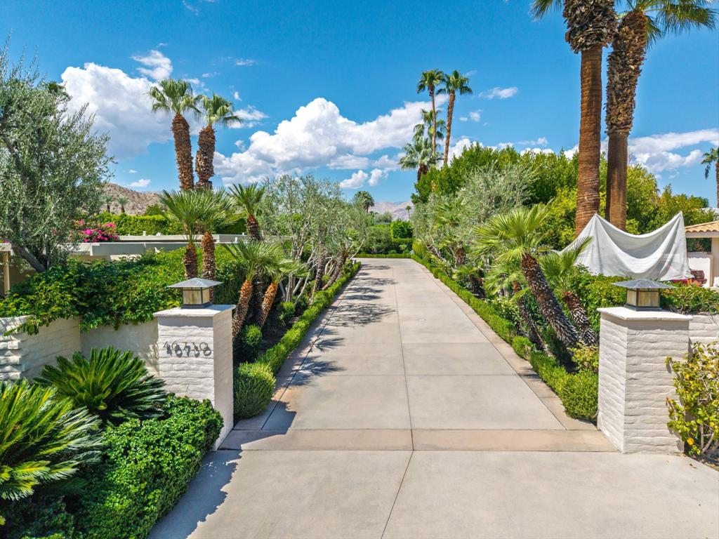 Come discover the beauty and warmth of this stunning home located on the 2nd fairway of Eldorado C.C. Built in 1990, this spacious 4,793 sq. ft. residence sits on an expansive 23,087 sq. ft. lot with sensational fairway views framed by the Santa Rosa foothills and Eisenhower Mountain beyond. As you enter through the custom gates, you are welcomed into a lush private courtyard that invites you to step inside through elegant double glass front doors. The moment you enter you'll find a bright and open formal entryway featuring soaring ceilings and opulent granite and travertine finishes that set the tone for the rest of the home.The expansive living and dining area, adorned with walls of glass on both the North and South sides, creates the perfect backdrop for both formal and casual gatherings. An impressive marble fireplace warms the space while magnificent views of the fairway and mountains enhance the serene ambiance. The wrap-around wet bar, complete with a sink and ice maker, ensures effortless entertaining for friends and family. The family room, located just off the kitchen, is designed for casual comfort and includes a breakfast bar with additional granite countertop space. Prepare to be inspired by the kitchen. This cook's haven features an island with a 4-burner GE stovetop, two Thermador ovens, a warming drawer, and so much more--your culinary adventures await The home also features a stylish powder bath adorned with a copper sink as well as a practical laundry room equipped with a utility sink. Two delightful guest en-suites provide perfect accommodations for family and friends. Guest #1 enjoys a private patio and a beautiful bathroom with Travertine finishes, while Guest #2 features en-suite with double sinks, picturesque views of the pool area and direct access to the outdoor retreat. Need a quiet space to work or unwind? The office, complete with a gas fireplace and built-in cabinets, opens up to the pool area, making it the perfect serene escape. The master en-suite is truly a retreat of its own, featuring a warm entrance, gas fireplace, and lovely built-ins. Enjoy breathtaking mountain views right from your bedroom and a luxurious bathroom that boasts a grand Jacuzzi tub, dual vanities, two walk in closets and a coffee bar with a beverage fridge for those cozy mornings. Step outside to your private oasis, where the inviting private pool area offers a spectacular space complete with outdoor kitchen and dining area to relax or entertain.
