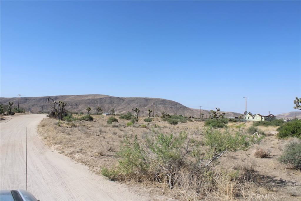 Nestled in the heart of Pioneertown, this 1.26-acre flat land / lot offers an amazing opportunity to create a bespoke desert retreat. With road access and utilities at hand, including water rights, the property is primed for development of a designer home and guest accommodations. Its enviable location boasts sweeping vistas of the Sand to Snow Monument and Sawtooth Ridge, ensuring breathtaking views by day and starry skies by night. Just minutes from the legendary Pappy and Harriet's, residents can enjoy live music and fine dining within walking distance, adding to the vibrant local culture. Whether envisioned as a modern ranch hideaway or an enchanting estate, this parcel combines tranquility with accessibility, making it an ideal canvas for realizing a dream desert residence. A 31 miles to Palm Springs. 67 miles to Big Bear. 124 miles to Los Angeles. Ideal for a modern ranch hideaway.
Adjacent parcel is also for sale, buy both for a combined 2.52 Acre lot!
(loctated right next to 5441 Minna Gombell Ln, Pioneertown Ca 92668 )
