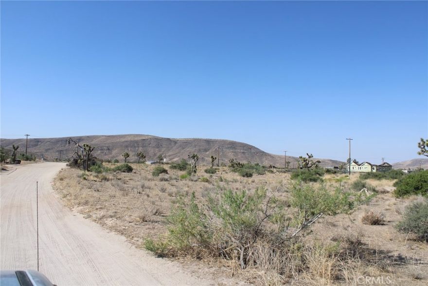 Nestled in the heart of Pioneertown, this 1.26-acre flat land / lot offers an amazing opportunity to create a bespoke desert retreat. With road access and utilities at hand, including water rights, the property is primed for development of a designer home and guest accommodations. Its enviable location boasts sweeping vistas of the Sand to Snow Monument and Sawtooth Ridge, ensuring breathtaking views by day and starry skies by night. Just minutes from the legendary Pappy and Harriet's, residents can enjoy live music and fine dining within walking distance, adding to the vibrant local culture. Whether envisioned as a modern ranch hideaway or an enchanting estate, this parcel combines tranquility with accessibility, making it an ideal canvas for realizing a dream desert residence. A 31 miles to Palm Springs. 67 miles to Big Bear. 124 miles to Los Angeles. Ideal for a modern ranch hideaway.
Adjacent parcel is also for sale, buy both for a combined 2.52 Acre lot!
(loctated right next to 5441 Minna Gombell Ln, Pioneertown Ca 92668 )