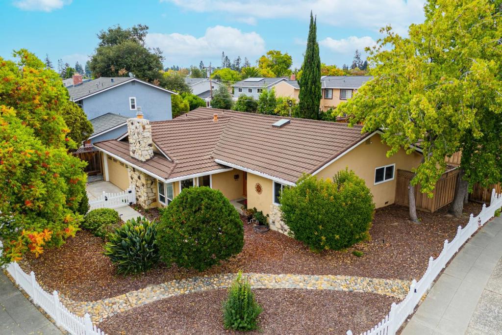 This move-in-ready home is nestled in the highly sought-after Happy Valley neighborhood of West San Jose. The spacious step-down living room features picture windows and a cozy gas fireplace. The bright, modern kitchen is a chefs delight, equipped with a top-of-the-line Wolf range, custom cabinetry, pristine white granite countertops, and a generous breakfast bar. An open dining area, illuminated by a grand skylight, flows effortlessly into the kitchen and out through sliding glass doors to a large covered patio and beautifully landscaped backyard. A private guest suite with a fully remodeled bathroom offers comfort and convenience for visitors or extended family. The luxurious primary bedroom boasts dual closets, direct access to the backyard, and an elegant en-suite bathroom with stylish tile flooring and granite countertops. Additional features include Milgard double-pane windows throughout, a whole-home water softener and filtration system, and a newer 200-amp electrical panel ready to support your EV supercharger.