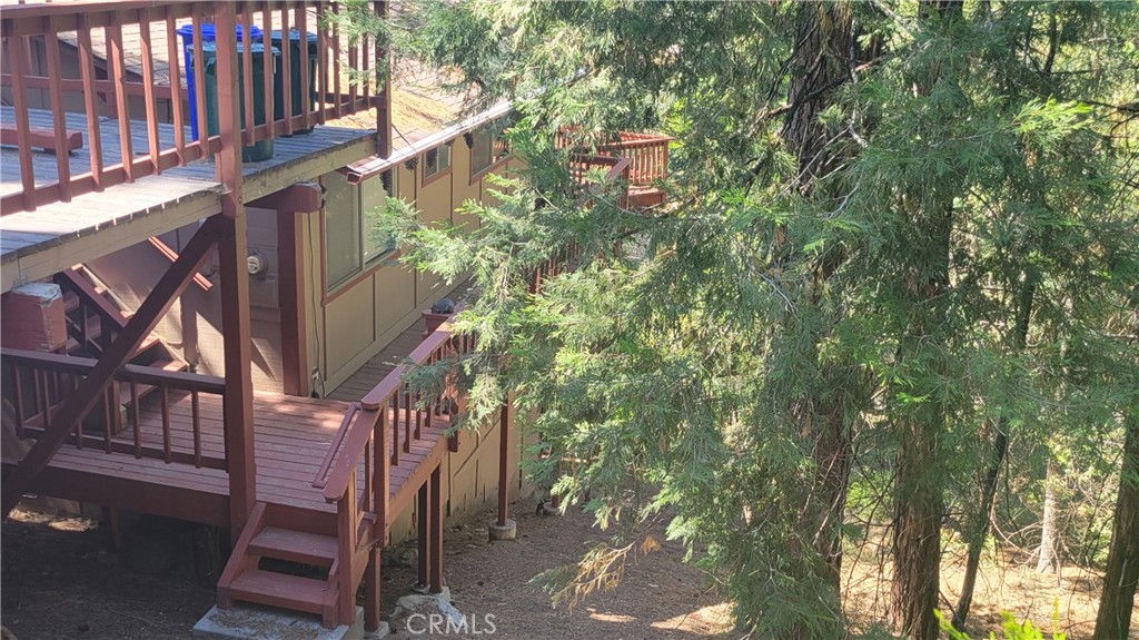 Your tree house cabin awaits! Welcome home to 26126 Boulder lane, where memories are ready to be made. Darling 2 bedroom cabin features vaulted ceilings and beautiful windows with nothing but tree views out the living room. Both bedrooms and a full bath are on the main floor. Downstairs holds a bonus room that's currently a game room space with a murphy bed to provide added sleeping space. There's abundant storage in the finished basement area and a utility room. Makes it easy to stock the house with all the supplies you'll need for extended stays.
Offered turn-key furnished and on a double lot, this Twin Peaks gem of a cabin checks all the boxes for space and convenience. Don't miss it on your next tour of mountain homes!
