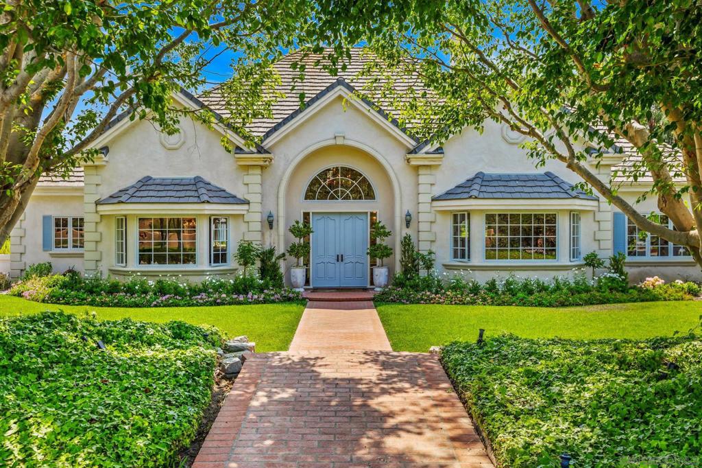 Timeless elegance meets everyday charm in this beautifully reimagined Fairbanks Ranch estate, perfectly located on the coveted North side. Set on nearly 2 acres of peaceful, tree-lined grounds, this warm and welcoming residence blends classic architecture with close to half a million dollars in thoughtful upgrades—creating a home that feels both grand and grounded. Inside, soaring ceilings and rich woodwork set the tone. A dramatic, wood-paneled library with fireplace offers a cozy retreat, while a private office overlooks manicured gardens. The family room flows into a chef’s kitchen with boxed beam ceilings, a butler’s pantry, and mudroom—each space enhanced for beauty and function. The main-level primary suite features dual ensuite baths, two walk-in closets, and French doors opening to a private patio with a resort-style pool and spa—ideal for entertaining, relaxing, or creating unforgettable moments with family. Upstairs offers two ensuite bedrooms, a bonus room, and two attic spaces—both being finished to add approx. 1,000 sq ft. Major upgrades include new solar, roof, exterior paint, landscaping, new HVAC, pool heater, water filtration system, garage flooring, and more. Fairbanks Ranch offers 24-hour guard-gated security, private lake, clubhouse, tennis and pickleball courts, riding trails, playgrounds, and a premier equestrian center. Come explore the house and see if you can find the hidden storybook treehouse—just one of many delightful surprises waiting for you.