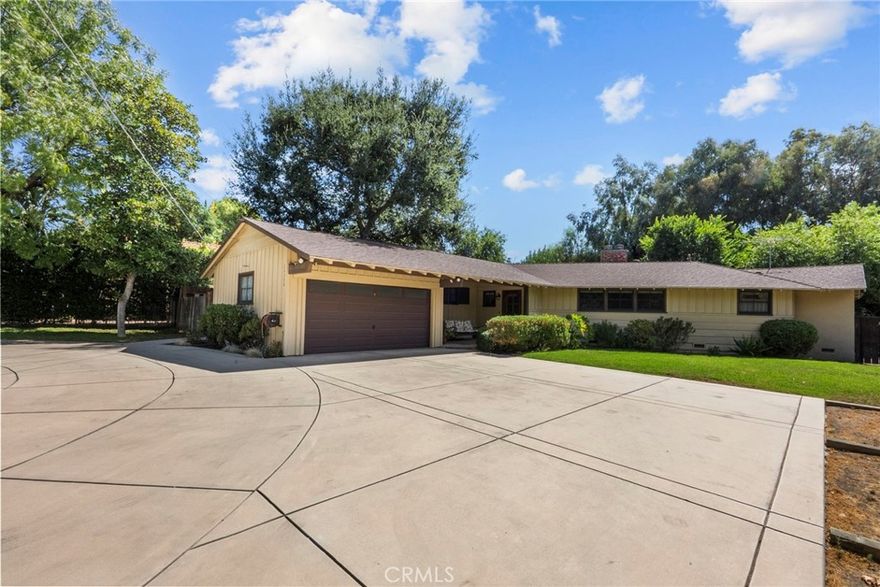 Step inside and instantly feel at home in this character-filled California Ranch offering 3 spacious bedrooms, 2 baths and a family room, spanning 1,458 Sq.Ft. of open and comfortable living space. The interior is rich with rustic charm, featuring warm wood-paneled walls, beautifully crafted open beam and vaulted ceilings, classic floor to ceiling brick fireplace and natural wood details/accents throughout. This cozy, well-maintained home creates a timeless, inviting atmosphere with a sense of elegance and architectural distinction which draws you in. Its expansive 13,535 sq.ft. lot is complemented by a beautiful, large circular driveway with plenty of off-street parking and endless possibilities for expansion, entertaining, gardening or future development including ADU's. Its unique location also provides convenient access for commuters while still maintaining a private-tucked away feel. This wonderful home is attractively and competitively priced and sure to go quickly. Schedule your showing today.
