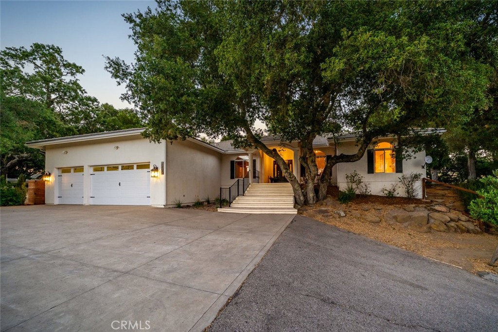 Welcome to this exceptional single-level home in the highly desirable Paradise Valley area of Atascadero, privately situated on nearly 4 serene acres. Built in 2003 and thoughtfully designed with over 2,500 square feet, this residence offers 4 spacious bedrooms, a dedicated office (optional 5th bedroom), and 2.5 bathrooms. Elevated above the street for added privacy, the home features a grand entry that opens to a stunning living room with vaulted ceilings, abundant natural light, a wood-burning fireplace with stone surround, and custom built-ins. The expansive kitchen is ideal for entertaining, complete with stainless steel appliances, granite countertops, a center island, and ample cabinetry, flowing seamlessly into the dining area and family room with French doors and a convenient powder room nearby. The well-planned split-wing layout provides privacy, placing the luxurious primary suite on one side of the home with dual walk-in closets, a gas fireplace, French doors to the back patio, and a spa-like ensuite with a jetted tub, separate shower, and picturesque views. The other three bedrooms and office are generously-sized and perfect for a large family. The oversized 3-car garage and generous driveway offer plenty of parking for guests. Outside, enjoy the peaceful setting with mature oaks, rock outcroppings, and fenced patios ideal for entertaining, gardening, or a dog run. A shed on the lower portion of the property adds versatility for storage or potential ADU. This is a rare opportunity to own a tranquil retreat in a coveted location. Seller will pay a maximum of 3% of buyer’s mortgage amount toward buyer’s loan points and/or non-recurring closing costs (no pre-paids or PMI)