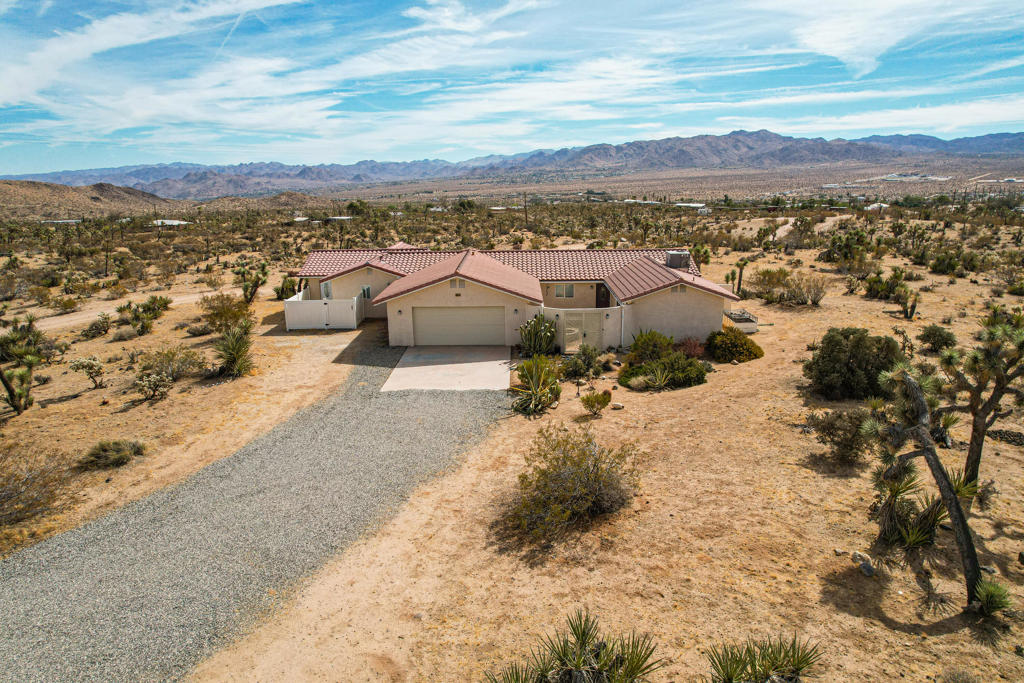 Welcome to 58979 Los Coyotes Drive -- a spacious and versatile home in the heart of Yucca Valley, set on nearly a full acre with stunning desert views.This 2,000+ sq. ft. property has just been refreshed with brand-new carpet, new interior paint, and new window treatments--all thoughtfully updated based on buyer feedback.Step inside to a warm and inviting living area with an open-concept flow, abundant natural light, and a kitchen designed for both daily living and entertaining. The kitchen features ample cabinetry, generous counter space, and brand-new stainless steel appliances, perfect for family meals or holiday hosting.What truly sets this home apart are the panoramic desert views visible from nearly every window.A standout feature is the attached private suite (ADU)--a 1-bedroom, 1-bath unit with its own entrance, kitchen, living room, and laundry. Ideal for guests, multigenerational living, or rental income potential.Outside, the property offers almost an acre of land ready for your vision, plus both the main home and ADU have private fenced courtyards.Additional highlights:New carpet installed May 2025Flexible floor plan with income/rental potentialQuiet location, just minutes from shopping, dining & Joshua Tree National Park2-car garage with plenty of storage and parkingThis home is move-in ready and better than ever. Schedule your private showing today and experience all that 58979 Los Coyotes Drive has to offer!