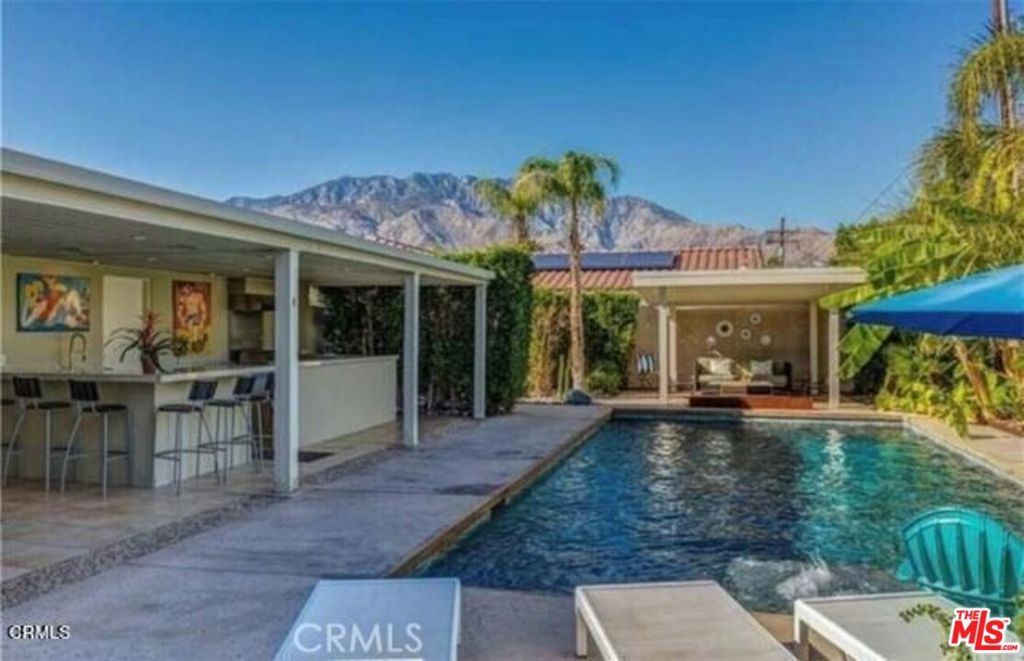 ELEGIBLE FOR SHORT TERM RENTAL PERMIT AND NO LAND LEASE in this gorgeous second or a house you can home with a mountain view, opening the gate you will face with little Oasis with a shade patio and a lounge area for your private chat... This home offers a wide open plan with 3 bedrooms and 2 bathrooms, central ac/heater, spa and pool heater with solar panels. At the back yard with a large sparkling salt water pool, above-ground jacuzzi, outdoor kitchen and dining area. Best of all no HOA you own the land RV ACESS. This property qualifies for permit/short term rental. Please be advised must schedule a showing due to short term occupant for full month. Furnishings are negotiable. DON'T LET YOUR CHANCE TO OWN A PRIVATE PARADISE IN THE HEART OF PALM SPRINGS PASS BY.