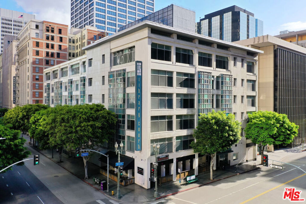 In the heart of Downtown LA, this bright one-bedroom condo at Library Court puts you close to museums and parks, with the Financial District at your doorstep and no commute required. The open layout feels spacious with high ceilings, wood flooring, and oversized windows framing views of tree-lined Sixth Street. The kitchen is finished with stainless appliances, blond cabinetry, and generous counter space. An enclosed bedroom provides privacy with room for a desk or larger furnishings; the bathroom includes a ceramic tiled floor and ample storage. Conveniences include in-unit laundry, central air, and a deeded parking space. Community amenities feature a zen garden, lounge, and a recently renovated gym. You're just minutes from Grand Central Market, MOCA, The Broad, and Crypto Arena, with Whole Foods, Spring Street Park, Pershing Square, and Little Tokyo all within easy reach, plus endless nightlife and shopping right outside your door.