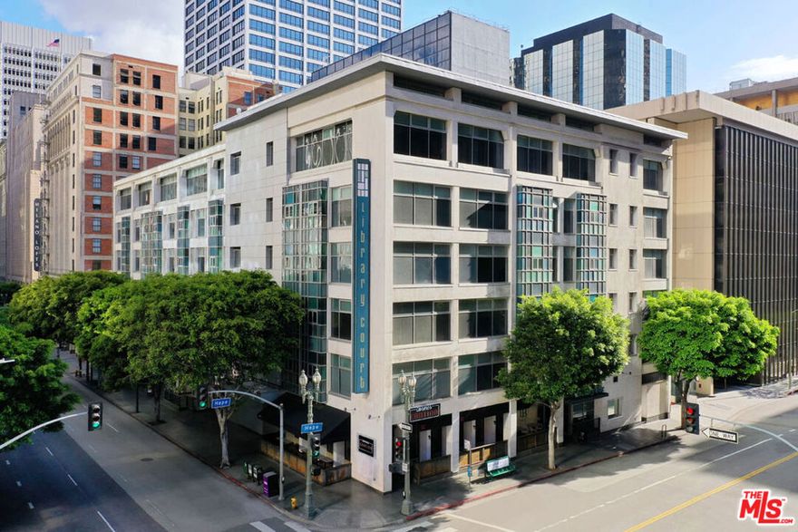 In the heart of Downtown LA, this bright one-bedroom condo at Library Court puts you close to museums and parks, with the Financial District at your doorstep and no commute required. The open layout feels spacious with high ceilings, wood flooring, and oversized windows framing views of tree-lined Sixth Street. The kitchen is finished with stainless appliances, blond cabinetry, and generous counter space. An enclosed bedroom provides privacy with room for a desk or larger furnishings; the bathroom includes a ceramic tiled floor and ample storage. Conveniences include in-unit laundry, central air, and a deeded parking space. Community amenities feature a zen garden, lounge, and a recently renovated gym. You're just minutes from Grand Central Market, MOCA, The Broad, and Crypto Arena, with Whole Foods, Spring Street Park, Pershing Square, and Little Tokyo all within easy reach, plus endless nightlife and shopping right outside your door.