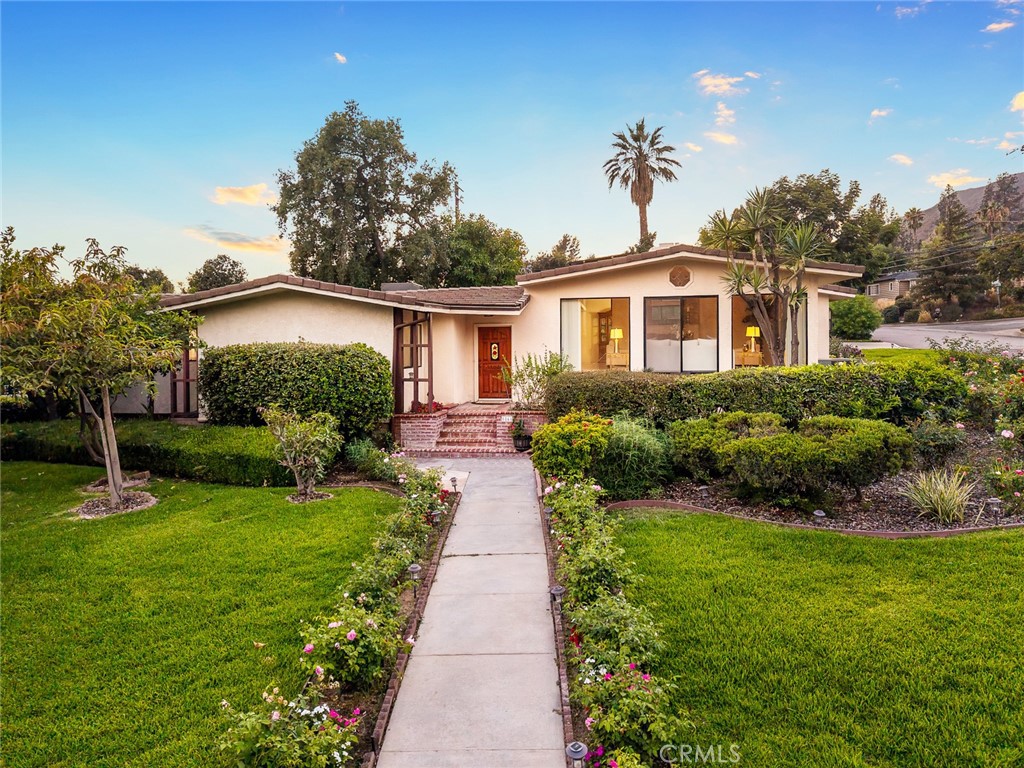 Nestled in the prestigious Highland Oaks neighborhood of Arcadia and part of the award-winning Arcadia School District, this beautiful and spacious home sits on one of the area’s most serene streets. On the market for the first time in over 40 years, Showcases true pride of ownership. This residence offers approximately 3,248 sq ft of comfortable living space on a Lush and artfully arranged 15,632 sq ft lot. The gracefully landscaped front yard welcomes you to a marble-tiled entry that leads into a sunlit formal living room, complete with a fireplace and a wall of glass that framing sweeping mountains views and the serene front garden. Adjacent is the formal dining room with view of a tranquil atrium. The remodeled gourmet kitchen features quartz countertops, granite flooring, custom cabinetry, and a bright breakfast area that opens to the side yard. The spacious family room includes a built-in bar and French doors leading to a peaceful backyard oasis with a large patio, mature trees, fruit trees, and a sparkling pool—perfect for entertaining. The thoughtful layout featuring four generous bedrooms, including a primary suite with walk-in closet, backyard views, and direct outdoor access. A separate bedroom and bathroom on the opposite side of the home provide ideal guest or in-law accommodations. A cozy den offers space for a home office or a gym. Additional highlights include a leased solar system, newer roof and HVAC, recessed lighting, a separate laundry room, and two-car garage. Located near Santa Anita Park, the Arboretum, Westfield, the 210 Freeway, and top dining and shopping, this home blends comfort, elegance, and the best of California living. A rare opportunity you won’t want to miss!
