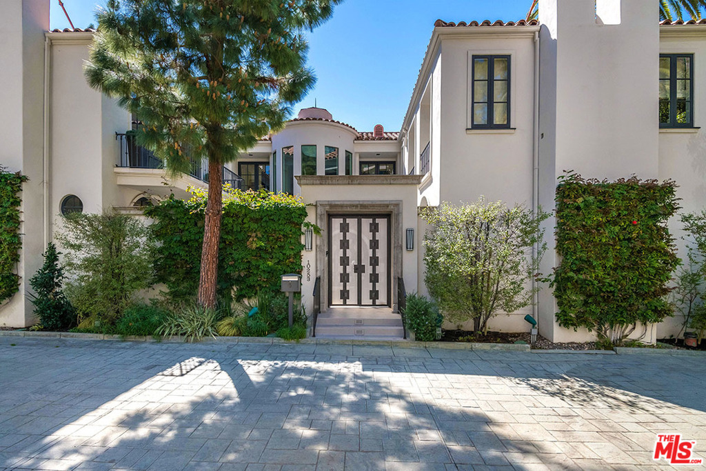 This elegant Mediterranean Villa located in the exclusive guard-gated community of Century Woods boasts ax. 6,000 sq.ft. of living space. Built around & opening to a central sun-drenched courtyard, the home offers high ceilings & generous public rooms including formal foyer, voluminous living rm w/built-in bar & formal dining rm. The gourmet kitchen features a large center island, professional appliances, butlers pantry & adjoining family rm. A downstairs maids bedroom & bth, separate laundry rm & powder rm complete the main level. Ascend the stairs or take the elevator to the second level, featuring an office, 2 guest bdrm suites, professionally equipped home theater w/bth, & wonderful master suite. The master suite is its own private retreat, w/sitting rm w/fireplace, private terrace, dual bths & walk-in closets. 3-car garage. Incredible opportunity to own a single family home in this secure & prestigious enclave. Community offers 2 pools, gym, recreation building & tennis court.
