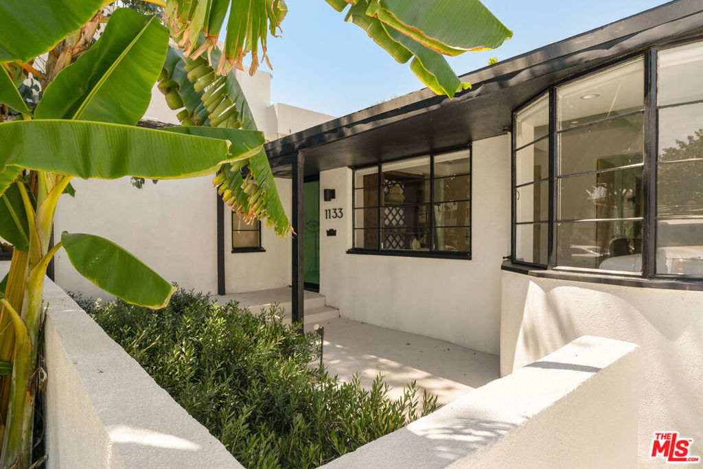 Welcome to 1133 S Cochran, a beautifully renovated single-family home nestled in the heart of Los Angeles. This spacious residence spans 2,102 square feet, offering 1930s streamline moderne flair paired with a beautiful blend of modern updates, including new plumbing, electrical and HVAC. Tucked into the Miracle Mile HPOZ, the home's gentle curve beckons you past historical windows to the front door. As you enter, stroll down the hallway to the main living area, where you'll find a versatile open floor plan. Dappled with sunshine from the skylight above, the dining room sits adjacent to the chef's kitchen and sizable island. Friends will be sure to gather around as you prepare a meal or banter with family in the large living room, which looks on to the comfortable, private backyard. Open the bi-fold doors to create the perfect indoor/outdoor flow and take advantage of the gorgeous LA weather. You'll find privacy and comfort in the primary bedroom as you cozy up to the fireplace and kick up your feet. With a walk-in closet, en-suite bath, soaking tub, double vanity and a large shower, you won't want to leave. A junior primary and an additional bedroom also offer en-suite baths and ample closet space. The third bedroom has a private entrance, perfect for a home office or income potential, while the two-car garage is ready for an ADU conversion or bonus studio space. Located in the sought-after Miracle Mile neighborhood, you're minutes to LACMA and the Academy Museum, local farmer's markets, famed restaurants like Republique and so much more. Pop up to The Grove or over to Culver City and Beverly Hills. This central location offers ease and accessibility like no other! Come take a look.