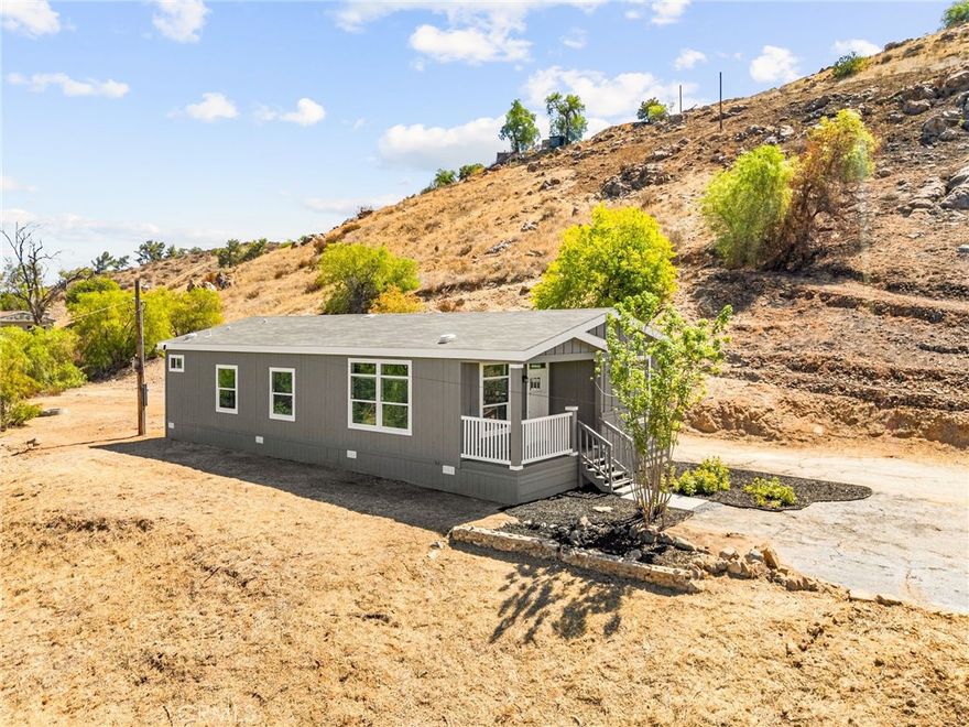 Tired of track home sized lots? This property is a little over 1.7 Acres giving you lots of privacy and assured no neighbors will build right on top of you. There is more than a 1/2 acre of use able land split between the upper pad and lower pad. Equestrian & Animal-Friendly Paradise Bring the horses, goats, chickens—you name it! This land is zoned W-2-M-1 and ready for your equestrian dreams or mini-farm vision. Home is ideally placed toward the front of the upper pad, allowing ample space in the back for a garage, warehouse, shop, or ADU. This stunning never-lived-in 3-bedroom, 2-bath home offers 1,493 sq ft of stylish living, all set on a generous 1.8-acre lot with room to breathe and grow. Whether you're dreaming of a peaceful country lifestyle or planning your next big adventure, this property delivers! ALL NEW EVERYTHING: Brand new septic system Brand new 200-amp electrical panel Brand new 1.5” water line Brand new HVAC system (to be installed before close of escrow) Permanent foundation for long-term peace of mind-433A Conveniently located just off Hwy 74, nestled between the 15 and 215 freeways—close to everything, yet offering the serenity of open land living.