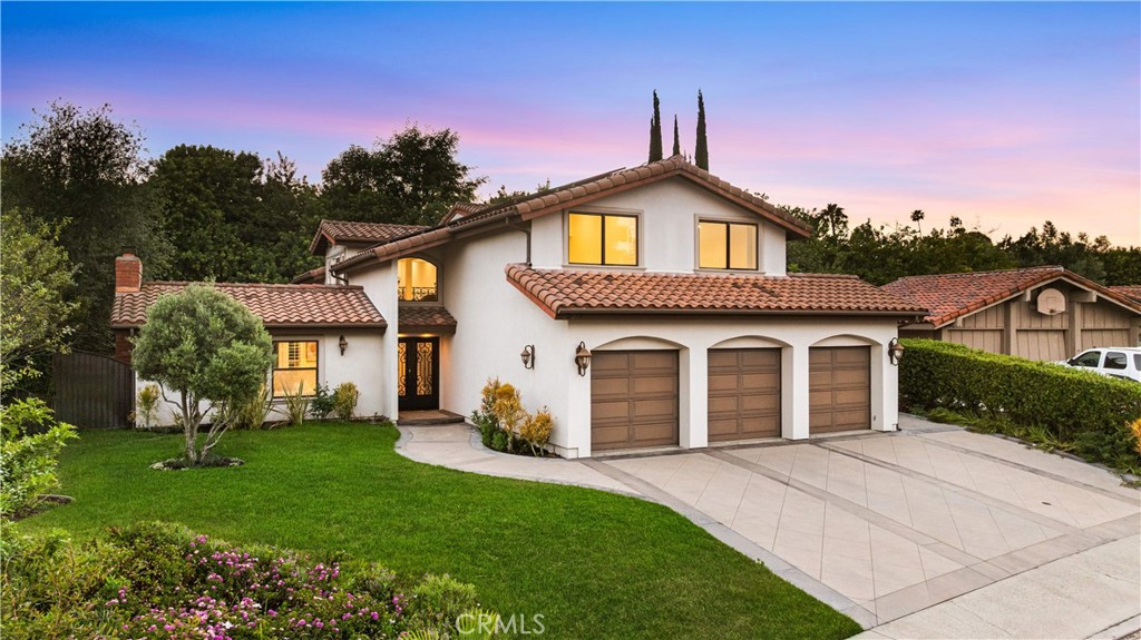 Utterly gorgeous and impeccably quiet, this custom ultra-luxury home in the prestigious Mission Ridge community of Mission Viejo sits at the end of a peaceful cul-de-sac and offers an exceptional blend of Mediterranean elegance and modern refinement. Rebuilt to perfection in 2008 and thoughtfully renovated just prior to listing, the residence features brand-new carpet, updated countertops, fresh interior paint, and is truly turnkey—ready for immediate move-in. Spanning approximately 4,400 square feet on an expansive 12,140 sq ft professionally landscaped lot, this 5-bedroom, 5-bathroom estate also includes a spacious loft, soaring ceilings, and exquisite architectural details. A lush garden-style front yard welcomes you into a grand entry with wrought iron double doors and elegant finishes, leading to a versatile multi-function room with a fireplace, elevated seating area, and glass doors that open to a serene backyard. The open-concept great room showcases travertine flooring and effortlessly connects the formal dining room, expansive living area, and chef’s kitchen—a true showpiece featuring a massive 5'x10' granite island, Thermador stainless steel appliances, and custom wood cabinetry. The main level includes a private en-suite bedroom, ideal for guests or multigenerational living. Upstairs, the bi-level primary suite boasts a private retreat space, spa-like bath with soaking tub, dual shower, and a large walk-in closet. A generous loft overlooks the lush yard framed by tall mature trees, while three additional bedrooms are thoughtfully positioned on the opposite side of the hall for added privacy. Additional highlights include French doors, wrought iron railings, double-pane windows, zoned HVAC, a premier solar energy system, ADT security, and a spacious 3-car attached garage. Residents enjoy access to Lake Mission Viejo and are served by top-rated Saddleback Valley schools including Mission Viejo High School, with convenient proximity to Mission Viejo Country Club, Recreation Center, shopping, and local parks. This is a rare opportunity to own a home that embodies timeless craftsmanship, smart upgrades, and luxury living at its finest.
