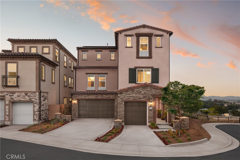Welcome to Elevate — The Terraces at Walnut, a stunning new Gated community located in the highly desirable Walnut neighborhood, served by the top-rated Walnut Valley Unified School District. This luxurious Plan 3 home offers a private and elevated living experience, featuring 5 bedrooms, 4.5 bathrooms, 3,728 sq. ft. of living space, and a 3-car garage. For added convenience, this home also offers an optional private elevator, providing effortless access across all levels. The gourmet kitchen, appointed with upscale cabinetry and designer countertops, is located on the second floor—perfectly designed for open-concept living and entertaining. The first floor features a separate guest or in-law suite, offering privacy and flexibility for multi-generational living. An expansive third-floor loft includes a large covered deck, an additional bedroom, and a full bath—ideal for a home office, entertainment space, or a private retreat. The peaceful backyard is perfect for outdoor living and gatherings.
Residents of this gated community enjoy access to 7 parks, playgrounds, BBQ areas, and picnic spaces—perfect for outdoor activities and social connections. As brand-new construction, buyers have the exciting opportunity to personalize interior finishes and select options—including the available elevator—to match their lifestyle.
Located in a premier area of Walnut, this exceptional property offers proximity to award-winning schools, shopping, dining, and local amenities.
Don’t miss your opportunity to own this stunning new home in the heart of the Walnut School District. Contact us today to schedule your private tour!
Note: Photos are of the model home and may not represent the actual home for sale.