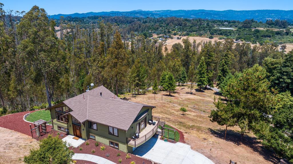Beautiful valley and mountain views on a rolling 7.9-acre parcel. This spacious 5-bedroom, 4-bathroom home offers 2,843 square feet of living space, with a blend of comfort and style. The kitchen is a chef's dream, featuring granite countertops, a gas range, electric oven, in a great room setting with walls of windows. Enjoy the seamless integration of the dining area within the living room, perfect for gatherings. The home boasts a separate family room, providing additional space for relaxation. Appreciate the modern amenities, including built-in vacuum, high and vaulted ceilings, walk-in closet, and a wet bar. Flooring options include elegant wood, tile, and carpet, adding warmth and variety throughout the home. Stay cozy, two wood burning stoves, and benefit from the convenience of central Heat / AC and radiant heating. The land offers many possibilities to realize your country home dreams. Dont miss the opportunity to see this amazing property.
