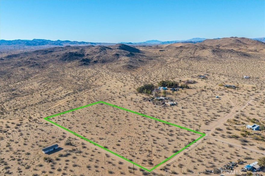 This stunning 5-acre parcel is nestled in a secluded desert cove, offering breathtaking 360-degree views and pristine desert vegetation. Despite its private setting, the property provides easy access to essential utilities, with power running along the east side and a stub out for a water meter already in place. An address has already been assigned, marking the first step in the permitting process and making development even more convenient. Surrounded by serene desert beauty, this land is the perfect canvas for your dream home, private retreat, or investment opportunity. While the setting feels remote and peaceful, you're just 20 minutes from the natural wonders of Joshua Tree National Park, the renowned cuisine at La Copine, and the shopping and dining options of Yucca Valley. This is a rare opportunity to own a piece of the high desert, where privacy, convenience, and spectacular landscapes come together. Don’t miss out—contact your agent today for more details!