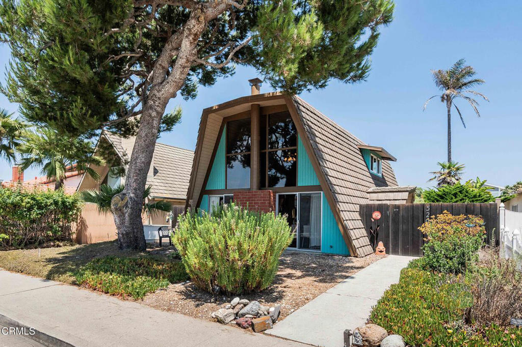 Midcentury Modern Coastal Gem - Steps to the Sand! You'll love this Architecturally significant A-Frame that is located on one of the rare all residential streets in Mandalay Shores. The beach and ocean are just steps away with a coastal access easement at the end of Beachcomber Street. Lovingly known as the McGrath Beach House and Tree House, it will delight you the moment you step inside the living room with it's soaring open beam ceilings and walls of glass. The wonderful floor plan has 3 bedrooms, 2 baths & a loft overlooking the main living area. Enjoy true indoor/outdoor living with the large front yard & sundeck. The covered open lanai is perfect for relaxing summer nights and barbecuing. This south facing residence features light grey-washed open-beam ceilings, wood plank flooring in the main living room, a cozy brick wood burning fireplace & an oversized 2-car garage. Additional parking for guests is available on Beachcomber Street. Come experience the charm, design, and lifestyle of the McGrath Beach House--your modern coastal haven awaits.