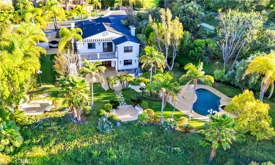 This opulent estate is set on over 1.25 acres, behind its own private gate within an exclusive 4 estate gated community. Perched high above El Caballero Country Club, the property offers endless views of the city lights and golf course. Nearly 5,500 sq ft of luxuriously appointed, recently remodeled living space welcomes you as you pass through the double wrought iron and glass doors into the grand foyer. Entertain guests in the 2-story, formal living room with fireplace or host parties in the spacious dining room. The chef’s kitchen features stainless steel appliances, breakfast area and center island and is ideally located to take full advantage of the yard while offering access to the large family room and bar. Maid’s quarters and an office round off the first floor. The master bedroom retreat rivals the most luxurious resorts in style, size and view and is accentuated by a large patio overlooking the manicured grounds and the entire SF Valley while the master bathroom features spa-like amenities. Three other upstairs bedrooms are all generously sized. The resort-like backyard offers multiple sitting areas, lush landscaping, an oversized covered patio, built-in BBQ, outdoor fireplace with a pizza oven and a lagoon shaped pool with spa. The home has a full home automation system which controls home audio, lighting and climate systems in addition to the full security surveillance.  *House can be rented furnished at a premium*