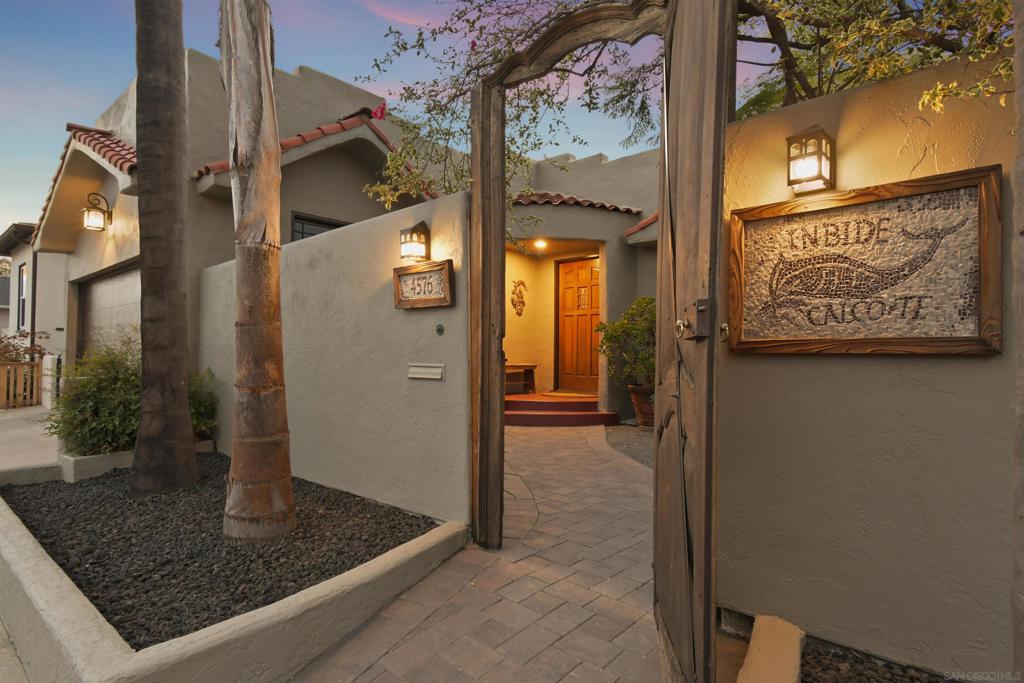 Within the decorative wrought iron gates of the Nationally Registered Historic District, Talmadge Park Estates, this contributing home built in 1928 has a private, courtyard entry through a centuries-old Italian cypress wood door, revealing the architectural details of this beautiful home in the wonderful community of Talmadge. French door windows flank the Talavera tile fireplace facade while the large picture window frames the tranquil view into the courtyard. Enjoy expansive sunset views across the mesa top of neighboring Kensington from the deck after adjourning from your entertainer's sized dining & living rooms. Hardwood & Saltillo tile floors, coved LR ceilings, Art Deco bathroom mirrors & original tile, and Talavera tile backsplash insets align with the old world feel echoing throughout this Spanish style gem. While the old-world charm & character enchants, the modern system upgrades impress with an entirely replaced foundation in 2006, replaced sewer lines, recent roof tune-up, tankless water heater and central heat & AC. Sets of sliding & French doors provide wonderful indoor/outdoor flow from the primary bedroom, the kitchen adjacent "butler's pantry" and dining room. Plenty of storage options afforded via hallway built-ins, "walk-in" closets, 2 car garage with high ceiling, and a partial walk-out basement with below deck entrance & wine storage racks. Walk to the local Copley-Price YMCA, find your way over to the neighboring village of Kensington, or enjoy convenient freeway access to local shopping or destinations around the globe from San Diego Intl Airport.