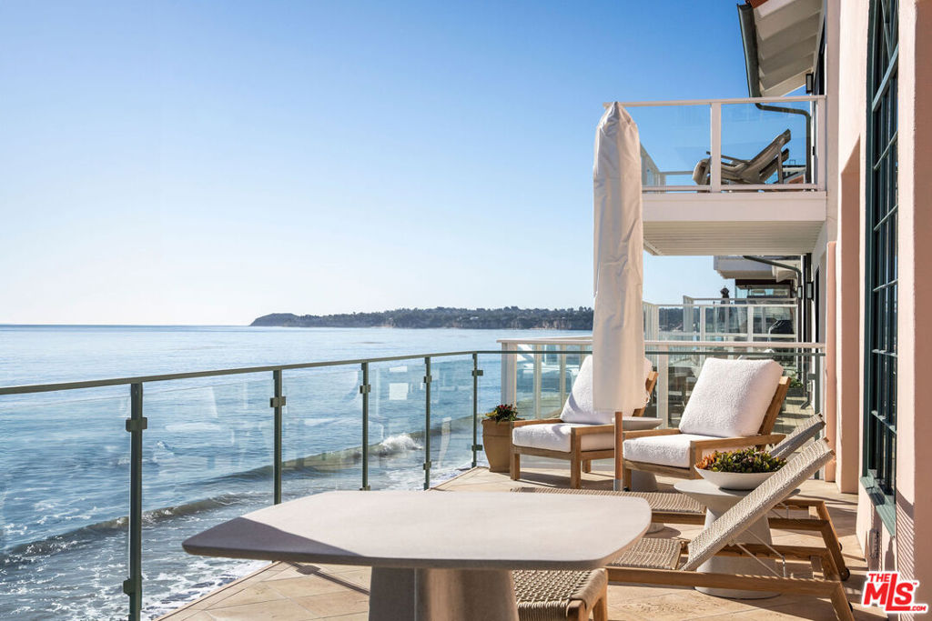 Welcome to an extraordinary coastal retreat in the exclusive Malibu Cove Colony, where oceanfront living meets timeless elegance. Situated on approximately 50 feet of sandy beach frontage, this stunning villa-style beachfront home offers 4,278 sq. ft. of casual sophistication, surrounded by the breathtaking beauty of the Pacific. From the Queen's Necklace to Point Dume, enjoy endless whitewater, ocean, and coastline views, making every day feel like a vacation.The home's grand entryway features vaulted ceilings that set the stage for its airy and light-filled design. The spacious living room boasts floor-to-ceiling windows and doors, a cozy fireplace, and spectacular ocean views that draw you onto the expansive oceanfront deck, spanning the entire width of the home. High beamed ceilings, recessed lighting, and travertine floors add warmth and elegance throughout the living spaces. The eat-in kitchen and adjoining areas offer private stairs leading directly to the surf and sand below perfect for spontaneous beach days. A charming den with courtyard access doubles as a media or family room and features its own inviting fireplace.On the second floor, the primary suite delivers unmatched ocean and coastline views, a spacious seating area, and a balcony where you can savor Malibu's iconic sunsets. The spa-like primary bathroom is ready for your personal touches and includes dual vanities, a soaking tub, shower, and a generous walk-in closet. Two additional bedrooms and another cozy sitting area complete this serene level.Whether you're lounging by the fireplace, dining on the oceanfront deck, or enjoying the natural light-filled interiors, this property epitomizes the quintessential Malibu lifestyle. A perfect balance of casual elegance and luxurious comfort, this home is more than a residence - it's a sanctuary to create unforgettable memories. Oceanfront Living at Its Finest Awaits You. Additional amenities/upgrades:*A two-car garage with built-ins, solar powered battery backup system for the house and laundry area.*EV Charger in garage*Private direct access to the sand with beach shower for seamless beach enjoyment. *Located moments from local markets, restaurants, and Malibu's finest offerings.*Nestled in one of Malibu's few guard-gated beach communities, ensuring privacy and exclusivity.*New landscaping with drip system Dec 2024*Lighting interior and exterior upgraded Dec 2024*All door hardware update Dec 2024*New Paint throughout house Dec 2024*New Sea Grass flooring second floor Dec 2024*All New Skylights Dec 2024*Roof was re-sealed Dec 2024*All Drainage has been flushed and cleaned Dec 2024*Solar panels on the roof - Owned