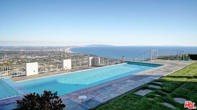 Located in the Prestigious Pacific Palisades Upper Marquez Knolls. This Contemporary Modern home is offers City, Mountain, Catalina Island, Santa Monica Bay, & picturesque ocean views. Just a short distance from Kobe Bryant's once owned estate! Grand Entry Foyer opens into an exquisite Entertaining room w/large sliding glass doors looking out onto the backyard & infinity pool w/views of the whole coast. 2 Master Suites w/his&her walk in closets, his&her sinks, views from your large soaking tub. Private Wine Cellar, maid's quarters, gourmet kitchen w/stainless appliances & custom cabinet, fabulous bar & sitting room to entertain guest, maid's room, library, & formal dining room! Located short distance from The Getty Villa, Annenberg Community Beach House, Riviera Country Club, Santa Monica 3rd St.Promenade & Temescal Canyon Park w/hiking trails to bring you back to nature. This property has so much to offer to you & your family. Become the next owner of this life changing Estate!