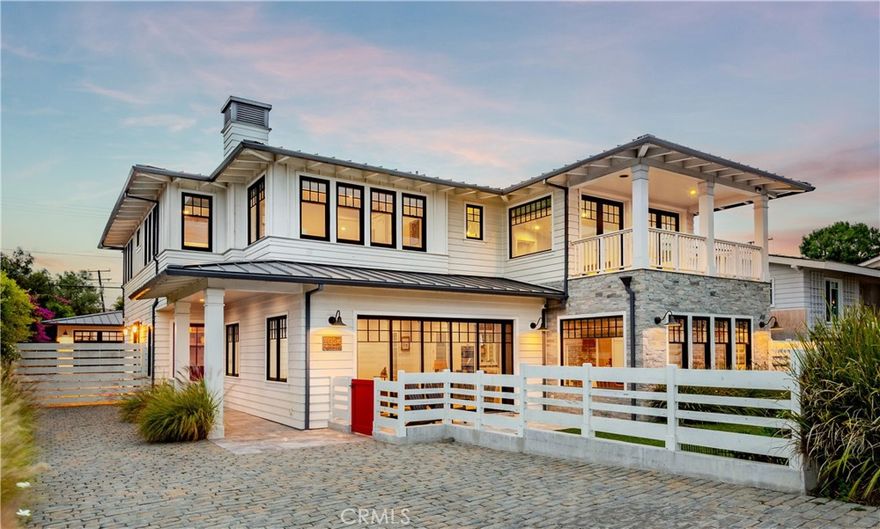 Built in 2017 from the ground up, this custom Coastal Farmhouse proves that true luxury is found in the details. Wide-plank wood floors, reclaimed barn wood, shiplap accents, exposed beams, and sleek Lowen black-metal windows set the stage for a home that feels timeless. At its center, the great room unfolds with a dramatic double-island kitchen complete with Wolf and Sub-Zero appliances, flowing effortlessly to the living room, formal dining room, and a pass-through pocket window to the outdoor bar, lounge with fireplace, and built-in BBQ. Upstairs, the primary suite is a private sanctuary with vaulted ceilings, French doors, a balcony, and sweeping ocean views, while the secluded, main level guest suite with its own entrance offers perfect hospitality. Downstairs, the 814-square-foot finished basement adapts as an exercise studio, playroom, or theater. Designed for California living, the saltwater pool, spa, fire pit, and multiple gathering spaces blur the lines between indoors and out, enhanced by Sonos sound with nine zones, Nest climate control, RTI automated lighting, and app-controlled pool systems. Capped with a standing-seam metal roof and surrounded by beautifully landscaped grounds with ample parking, this is more than a home, it’s a statement of design, lifestyle, and innovation.