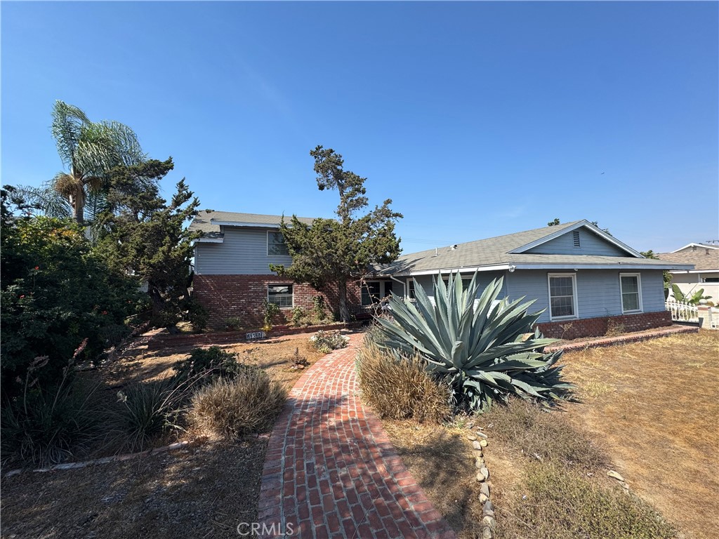 Located in the desirable city of Orange, California, this beautiful two-story single-family residence at 3801 E Spring Street offers a comfortable and spacious living environment. Built in 1965, the home has 5 bedrooms and 2.5 bathrooms, spread across 1,881 square feet of living space. The interior features a loft, a main-floor primary bedroom, and a fireplace in the living room, adding both charm and functionality. The property also includes a private, in-ground pool, perfect for relaxation and entertaining. Situated on a generous 7,800 square foot lot, the property offers a large backyard with a patio, as well as a private, gated parking area that can accommodate multiple vehicles, including potential RV or boat storage. A two-car attached garage provides additional parking and storage space, with laundry hookups conveniently located inside. This home is part of a quiet neighborhood with sidewalks and is served by the Orange Unified School District. It's conveniently located with easy access to major cross streets like Chapman Ave and Prospect Ave. WELCOME HOME...